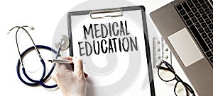 Doctor holding pen and paper plate with text MEDICAL EDUCATION, medical concept