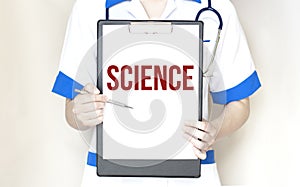 Doctor holding a pen and paper plate with text SCIENCE, medical concept