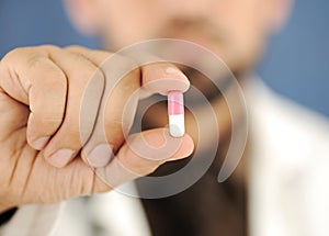 Doctor holding a pill, solution for you,