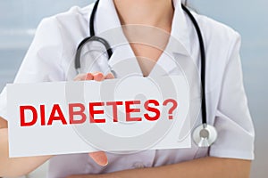 Doctor holding placard with diabetes text