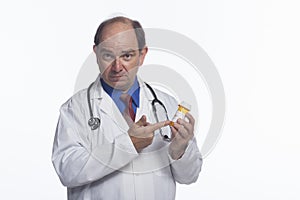 Doctor holding and pointing at prescription bottle, horizontal