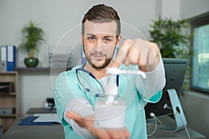 Doctor holding pump dispenser antibacterial handwash