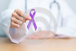 Doctor holding purple Ribbon for Violence, Pancreatic, Esophageal, Testicular cancer, Alzheimer, epilepsy, lupus, Sarcoidosis and