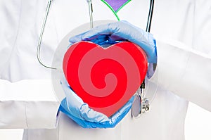 Doctor holding red heart