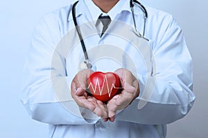 Doctor holding a red heart. healthy care concept