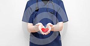 The doctor is holding a red knitted heart. Cardiology. Coronavirus, covid-19, healthcare concept