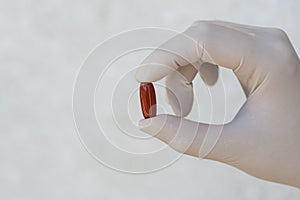 Doctor holding red pill