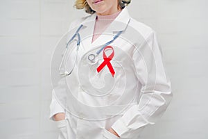 Doctor holding red ribbon. AIDS, HIV