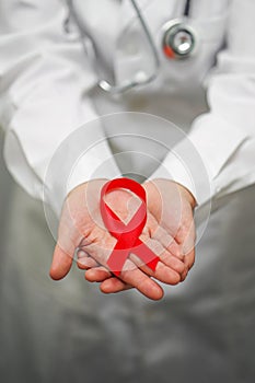 Doctor holding red ribbon. AIDS, HIV