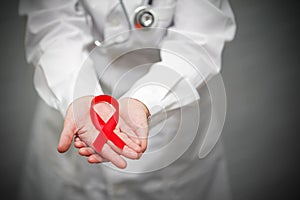 Doctor holding red ribbon. AIDS, HIV