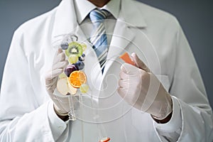 Doctor Holding Saline Bag With Fruit Slices Inside In Hospital photo