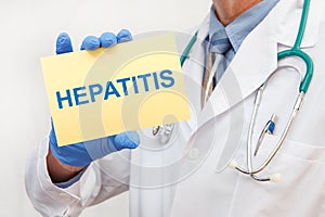 Doctor holding sign with text HEPATITIS closeup