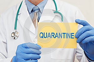 Doctor holding sign with text QUARANTINE closeup