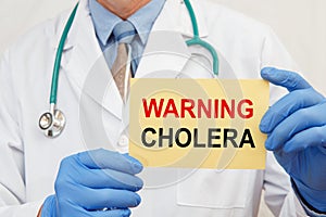 Doctor holding sign with text Warning Cholera closeup