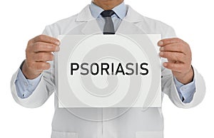 Doctor holding sign with word PSORIASIS on white, closeup