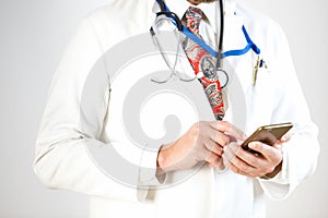 The doctor is holding a smartphone in a case, white background