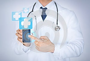 Doctor holding smartphone with medical app photo