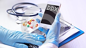 Doctor holding a smartphone with text DDX Differential diagnosis, medical concept