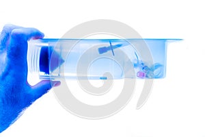 Doctor holding sterile disposable syringe in clean blue medical photo