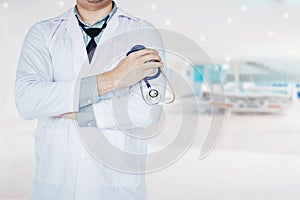 Doctor holding a stethoscope on background of hospital ward