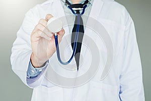 Doctor holding a stethoscope on background of Hospital ward