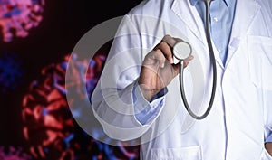 a doctor holding a stethoscope with blurred corona virus background