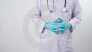Doctor is holding stethoscope in hand with wearing blue latex gloves on white background