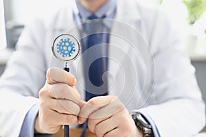 Doctor holding stethoscope infected with coronavirus, determining prognosis disease during pandemic