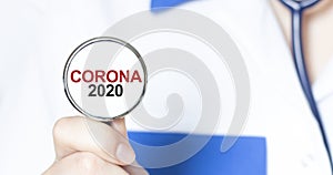 Doctor holding a stethoscope with text CORONA 2020, medical concept