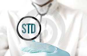 Doctor holding a stethoscope with text STD, medical concept