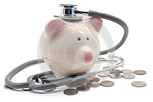 Doctor Holding Stethoscope to Piggy Bank