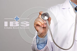 Doctor holding a stethoscope and word