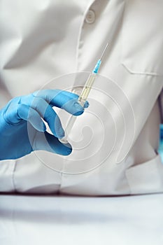 Doctor holding a subcutaneous vaccine of preventive medicine in the medical office