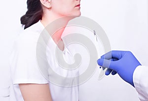 Doctor holding a surgical scalpel on the background of a girl with throat disease, concept of removing adenoids by