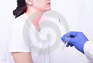 Doctor holding a surgical scalpel on the background of a girl with throat disease, concept of removing adenoids by photo