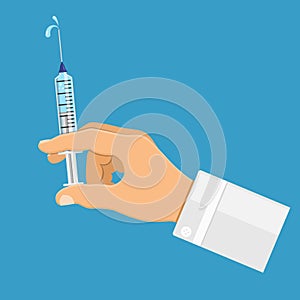 Doctor holding syringe in hand