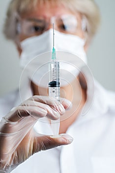 Doctor preparing a dose for a patient of the third vaccine for Covid-19