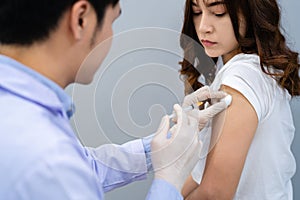 Doctor holding syringe and using cotton before make injection to patient. Covid-19 or coronavirus vaccine