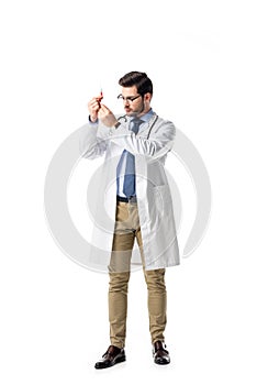 Doctor holding syringe wearing white coat with stethoscope