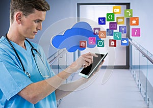 Doctor holding tablet with apps in modern corridor