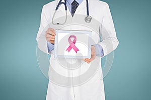 Doctor holding a tablet with a breast cancer awareness ribbon on screen