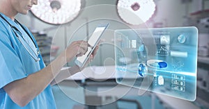 Doctor holding tablet with interface in surgery operating theatre