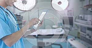 Doctor holding tablet in surgery operating theatre