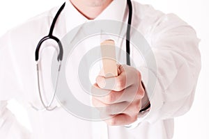 Doctor holding tongue depressor