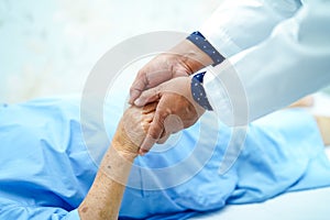 Doctor holding touching hands Asian senior or elderly old lady woman patient with love, care, helping, encourage and empathy.