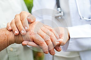 Doctor holding trembling hand photo