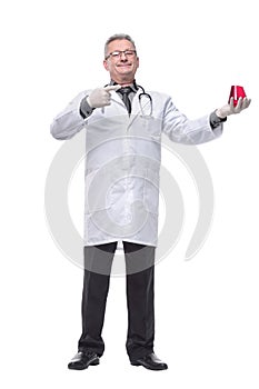 Doctor holding up beaker of red chemical in the laboratory