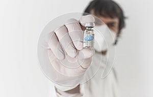 Doctor holding a vaccine bottle and syringe, beginning of mass vaccination with the Pfizer-BioNTech COVID photo