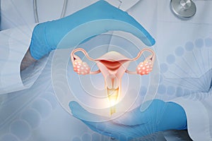 Doctor holding virtual image of uterus, closeup photo