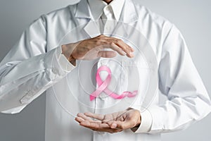 Doctor holding virtual pink ribbon cancer, Breast cancer awareness